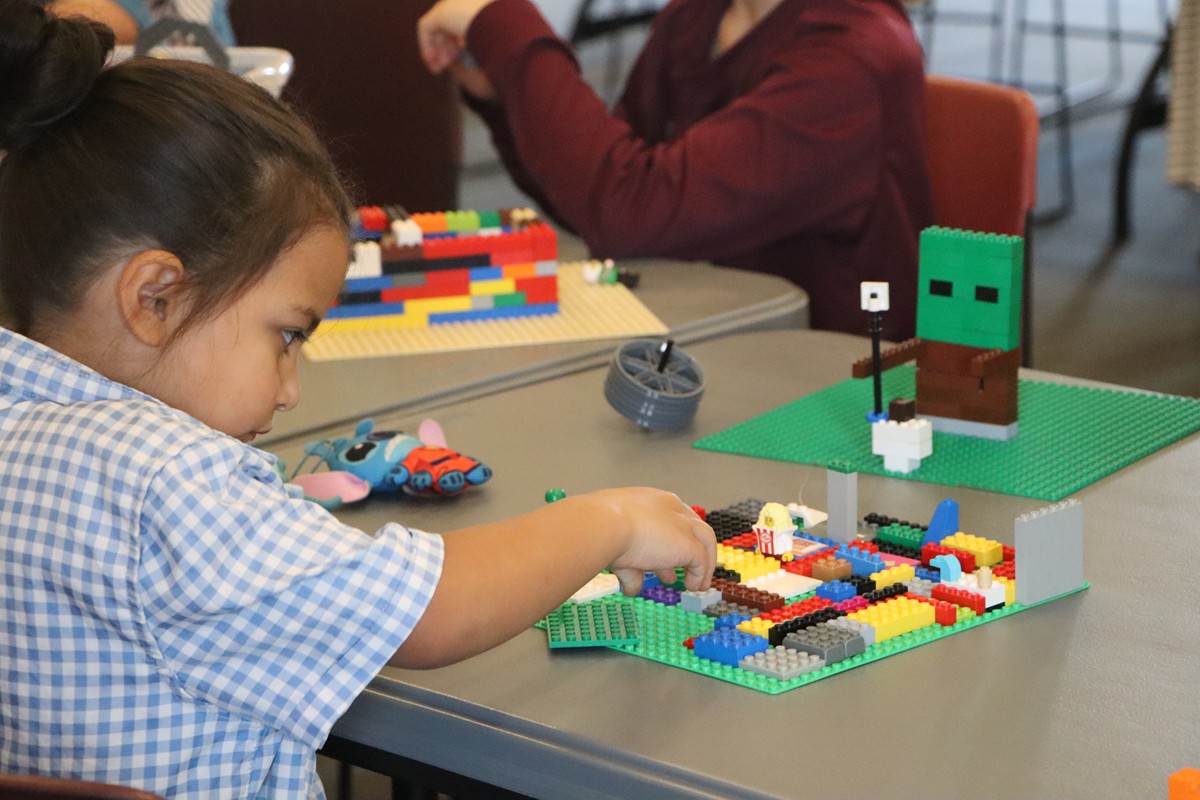 Child building with LEGOS