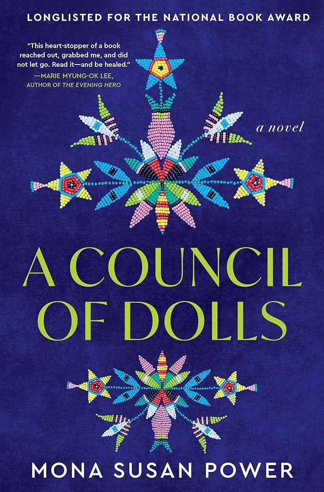 Cover of "A Council of Dolls" by Mona Susan Power features colorful beadwork patterns on a deep blue background, evoking a traditional and vibrant design.