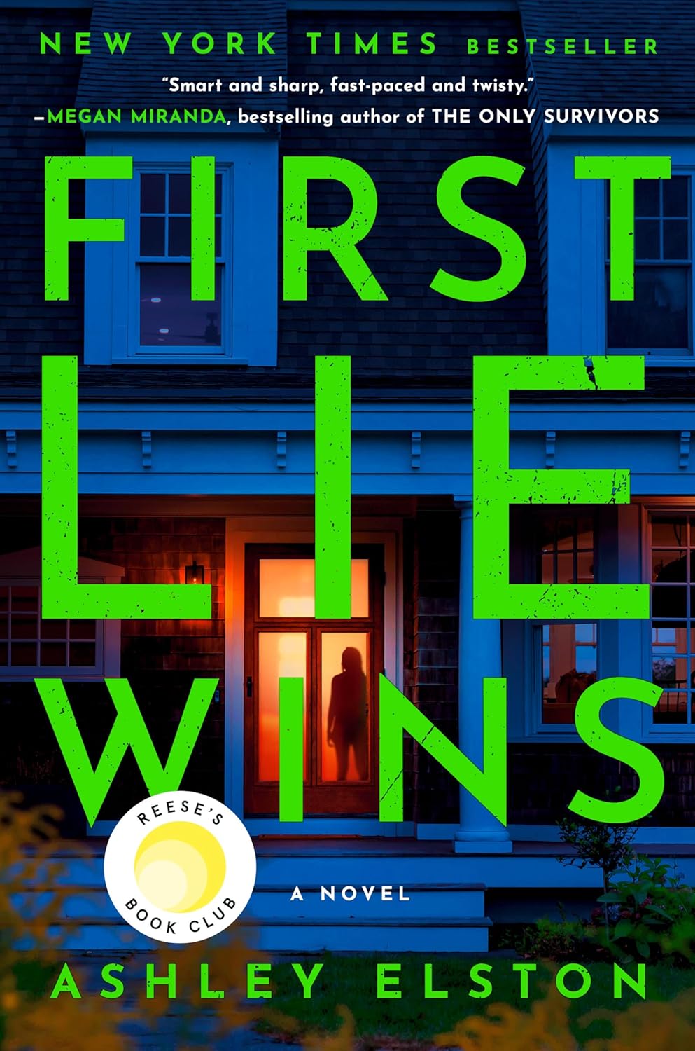 Book cover of "First Lie Wins" by Ashley Elston. A shadowy figure stands in a warmly lit doorway, framed by a dark house. Bold green title text.