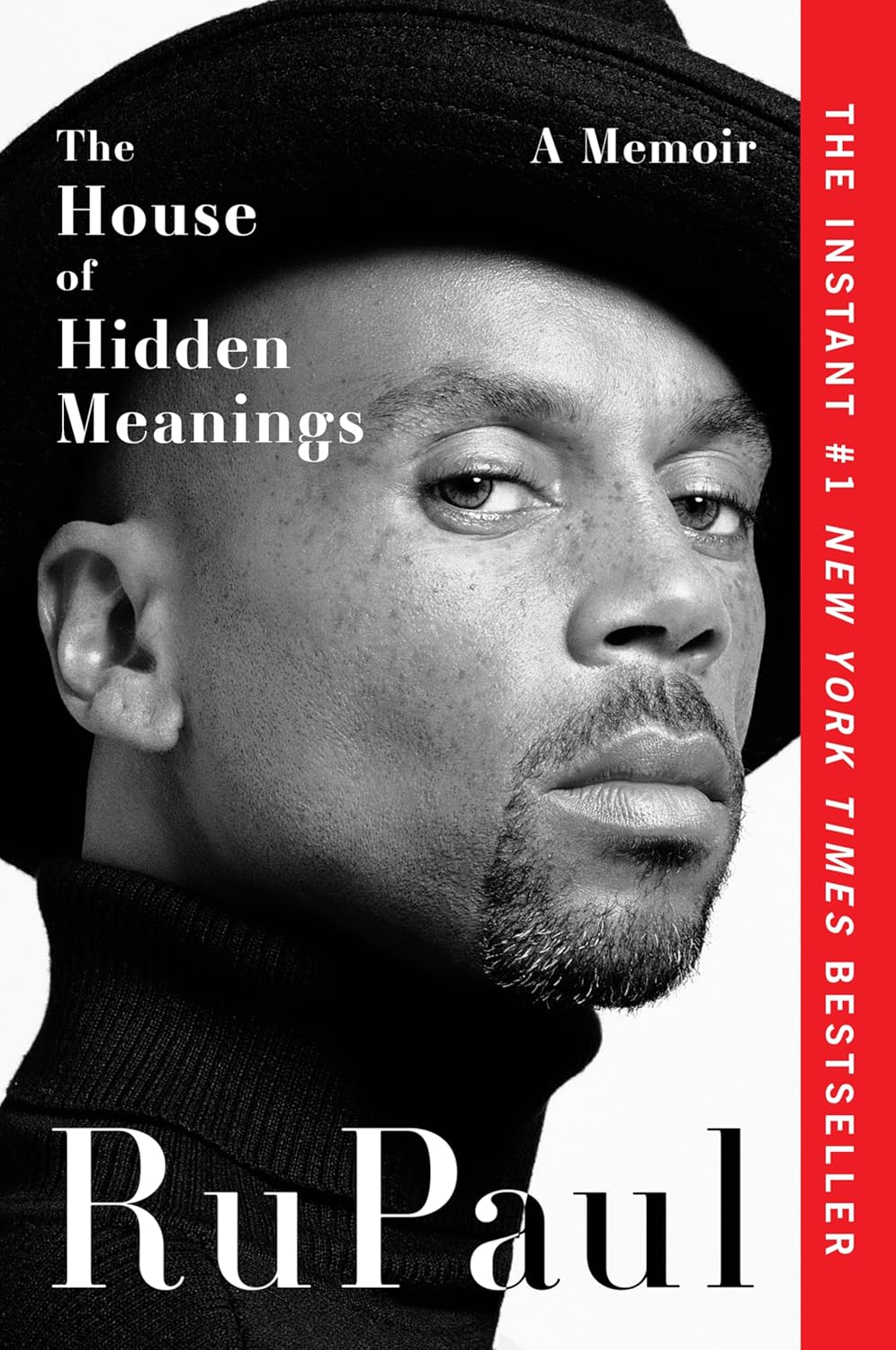 Black-and-white book cover featuring a close-up of a person's face wearing a hat, looking thoughtful. Text: "The House of Hidden Meanings, A Memoir" by RuPaul. Stylish and bold.