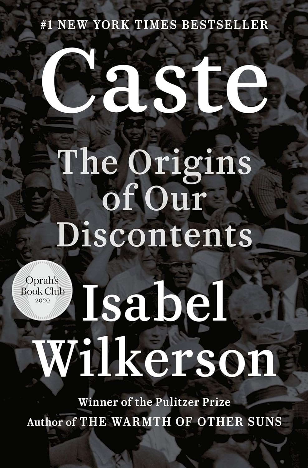 Cover of "Caste: The Origins of Our Discontents" by Isabel Wilkerson. Features a black-and-white crowd scene, highlighting diverse faces and expressions. Text overlay notes it's a #1 New York Times Bestseller and an Oprah’s Book Club 2020 selection.
