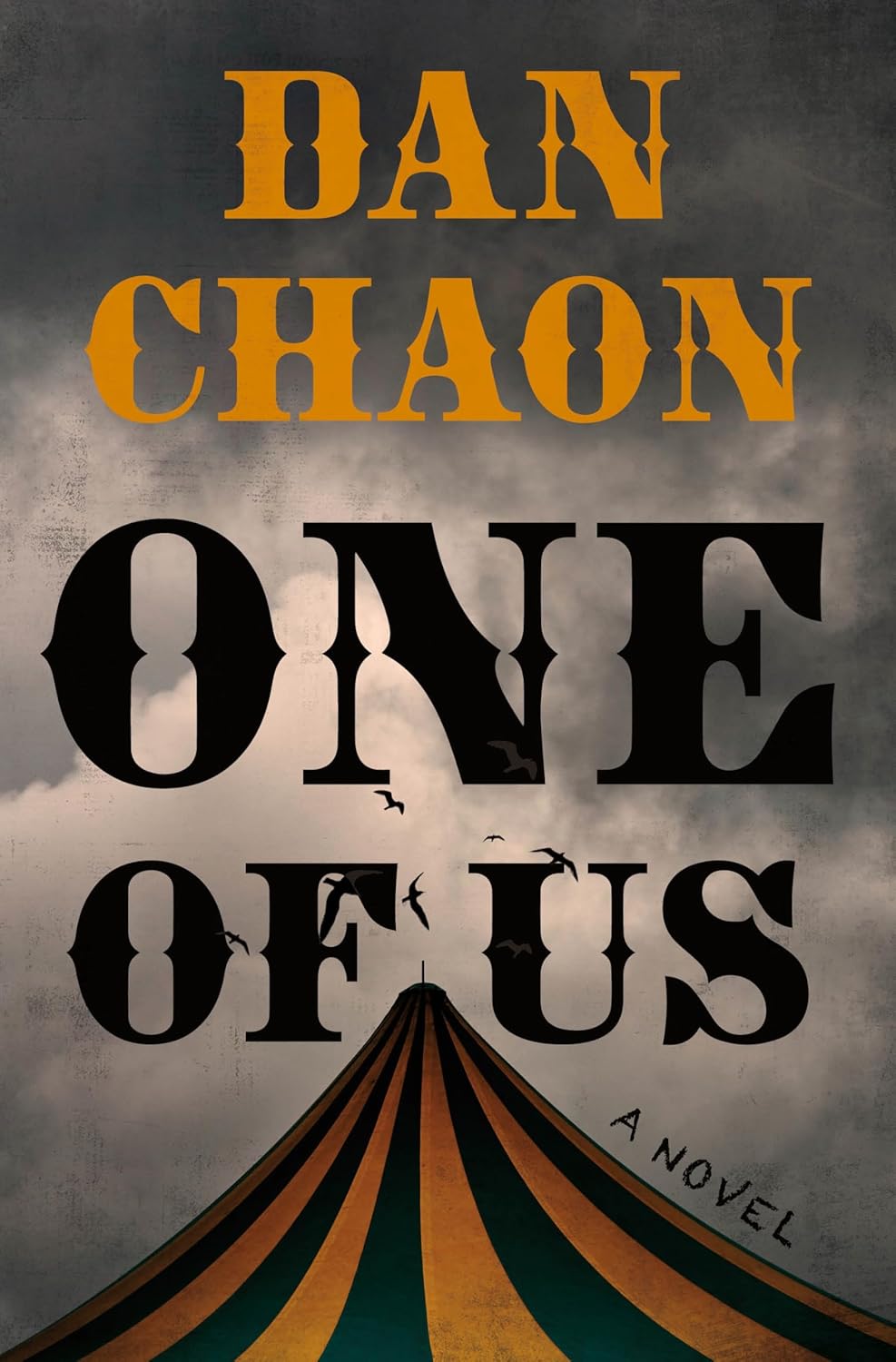 Cover of "One of Us" by Dan Chaon features bold orange and black text over a stormy sky. A striped tent peak suggests a mysterious, eerie tone.