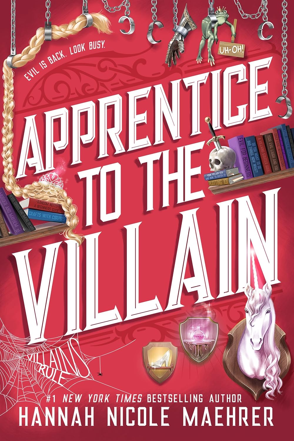 Red book cover titled "Apprentice to the Villain" by Hannah Nicole Maehrer, features chains with tools, a unicorn, skull, books, and a broom. Tone is whimsical.